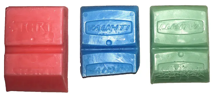 Three wax bars in different colors.