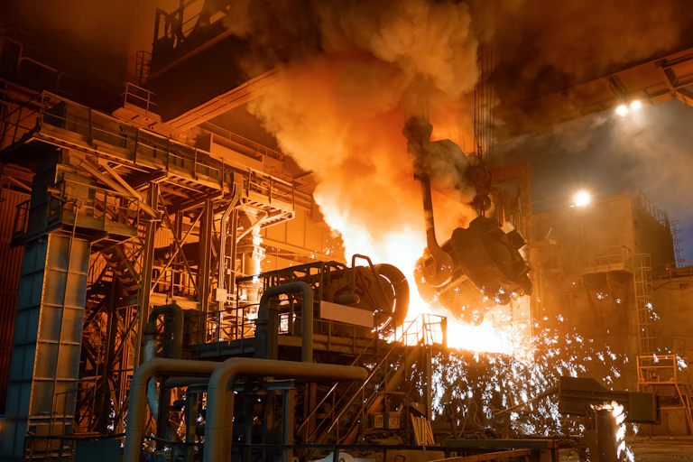 electric arc furnace, molten metal in industrial facility.