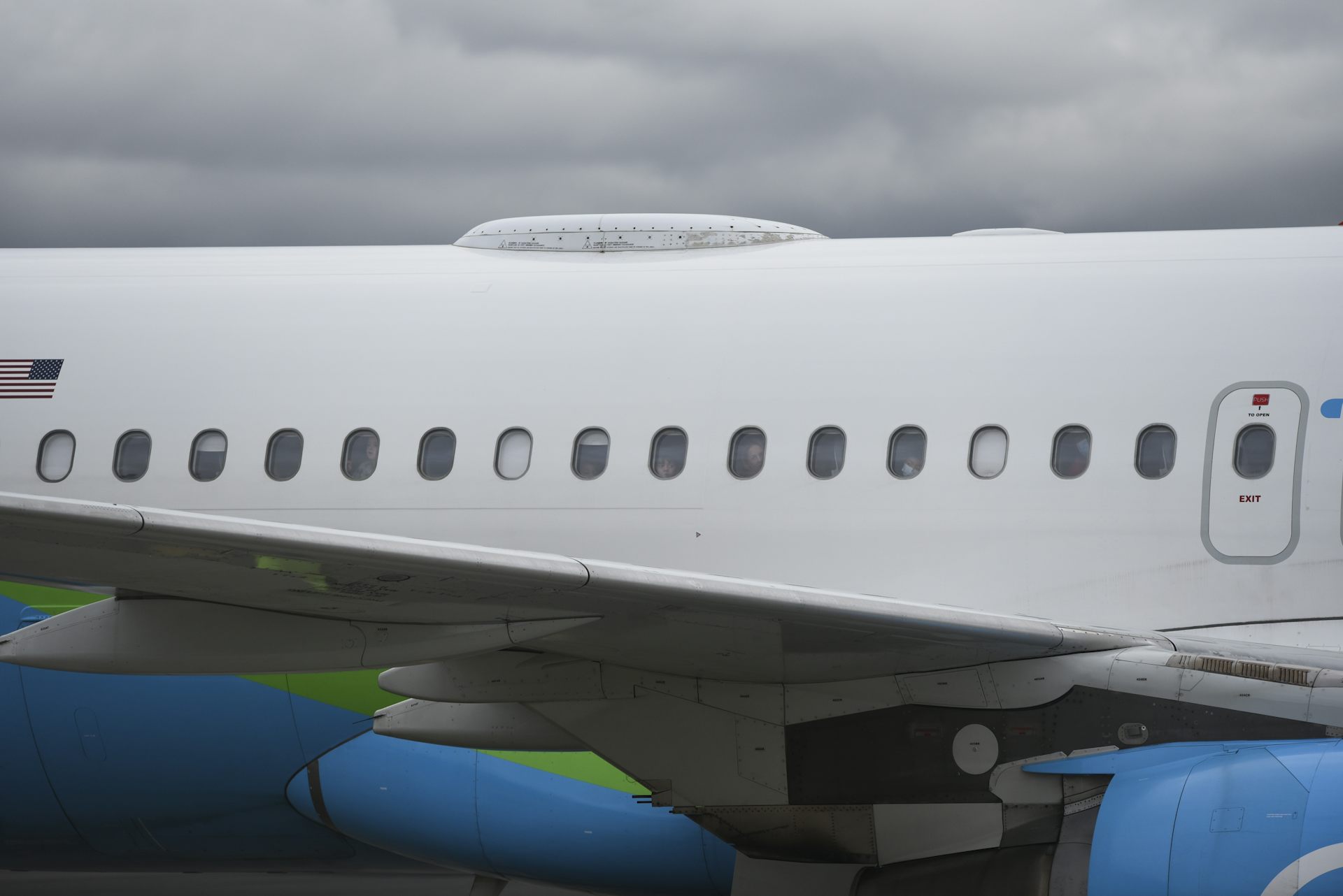 the body of a jetliner with the blinds down on some windows