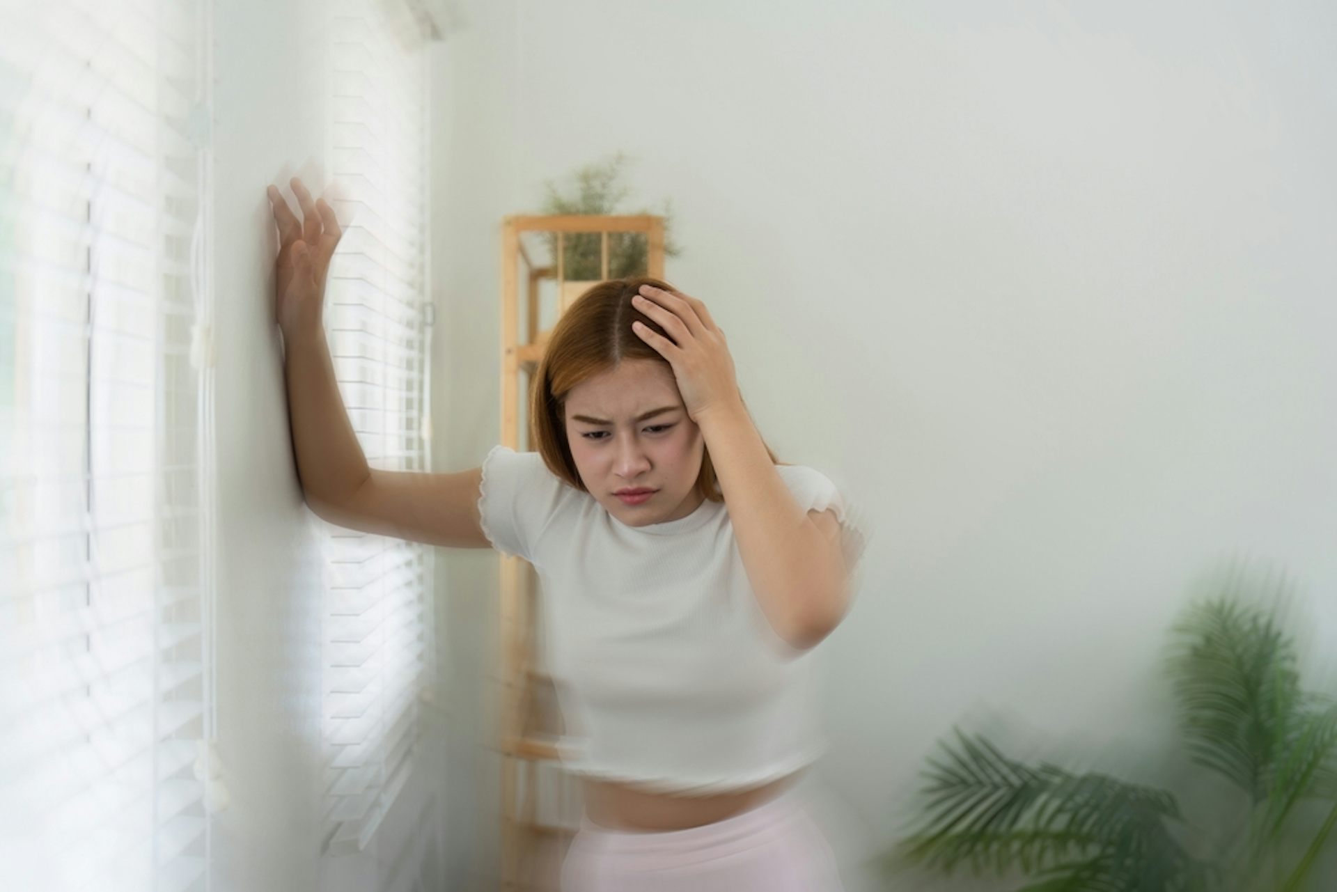 A young woman feeling dizzy.