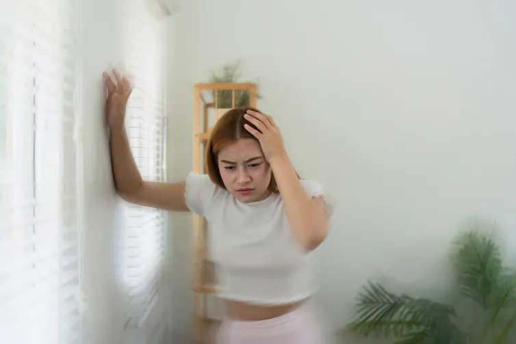 A young woman feeling dizzy.