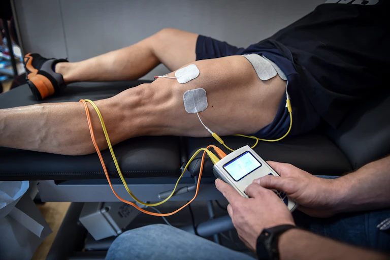 EMS electrodes applied to a man's legs.
