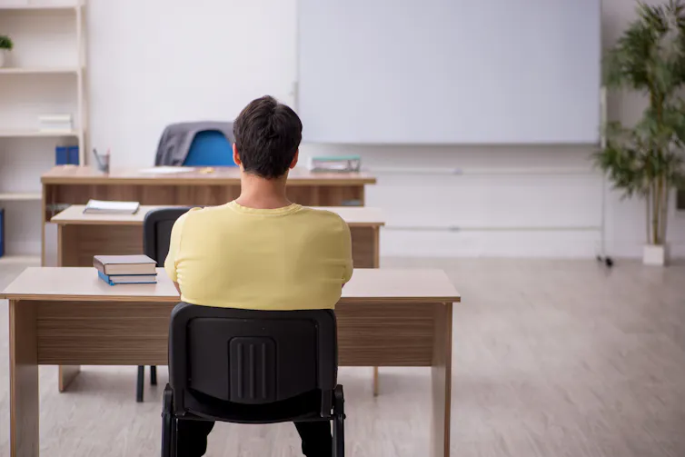 man sat alone in classroom