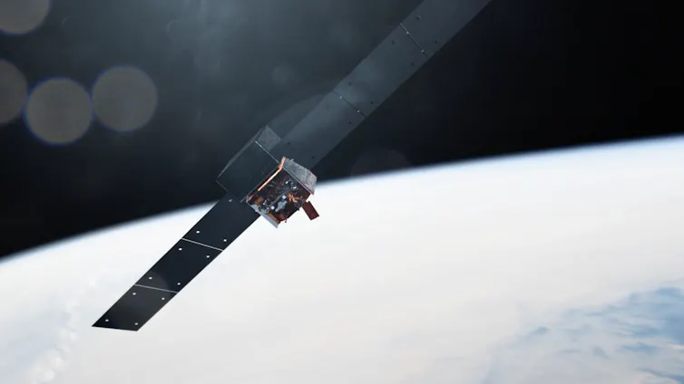 An illustration of the Fermi telescope in orbit over Earth. It looks like a metal box with two solar panels protruding off either side.