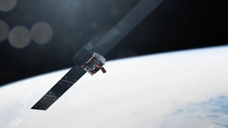 An illustration of the Fermi telescope in orbit over Earth. It looks like a metal box with two solar panels protruding off either side.