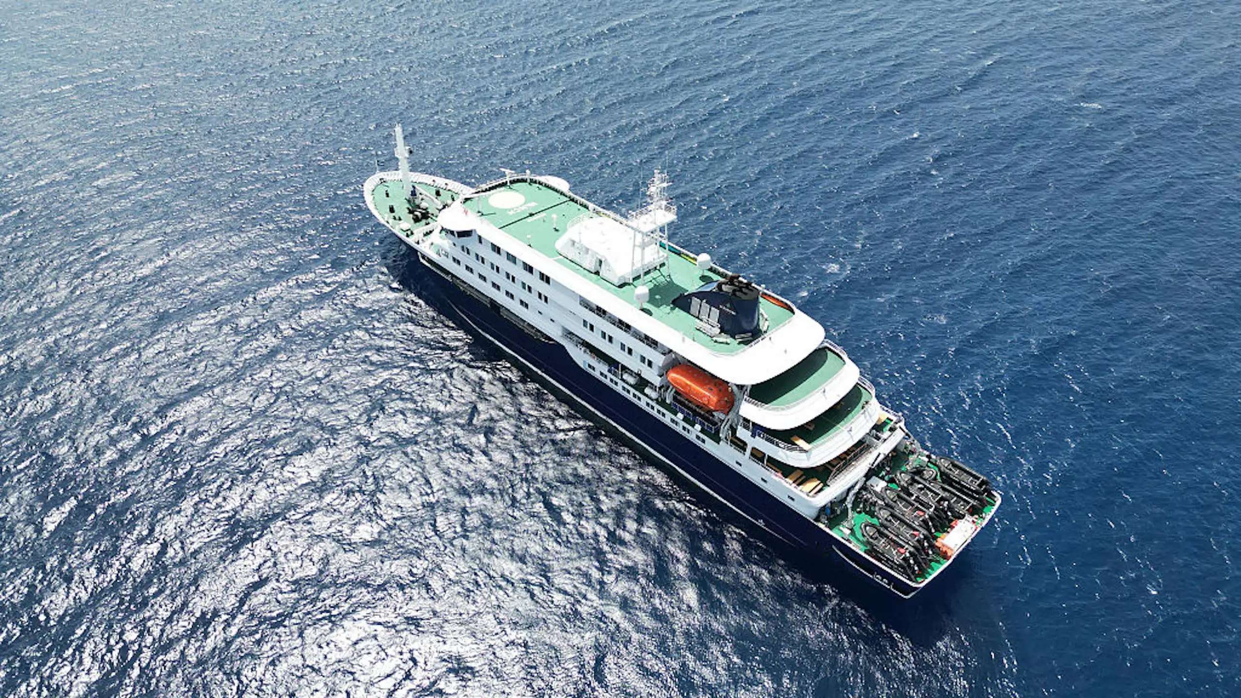 Birds-eye view of a cruise ship on the water.