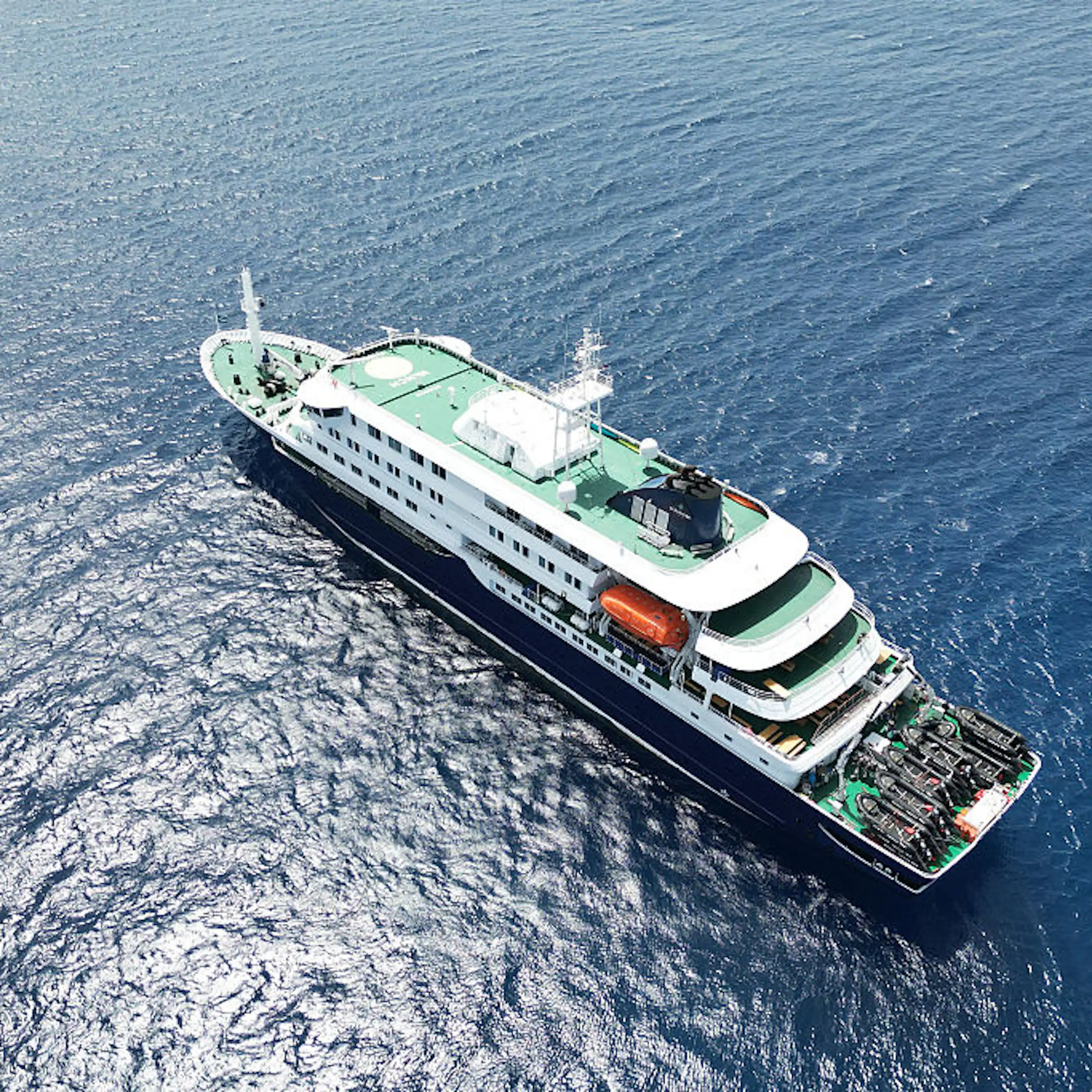 Birds-eye view of a cruise ship on the water.