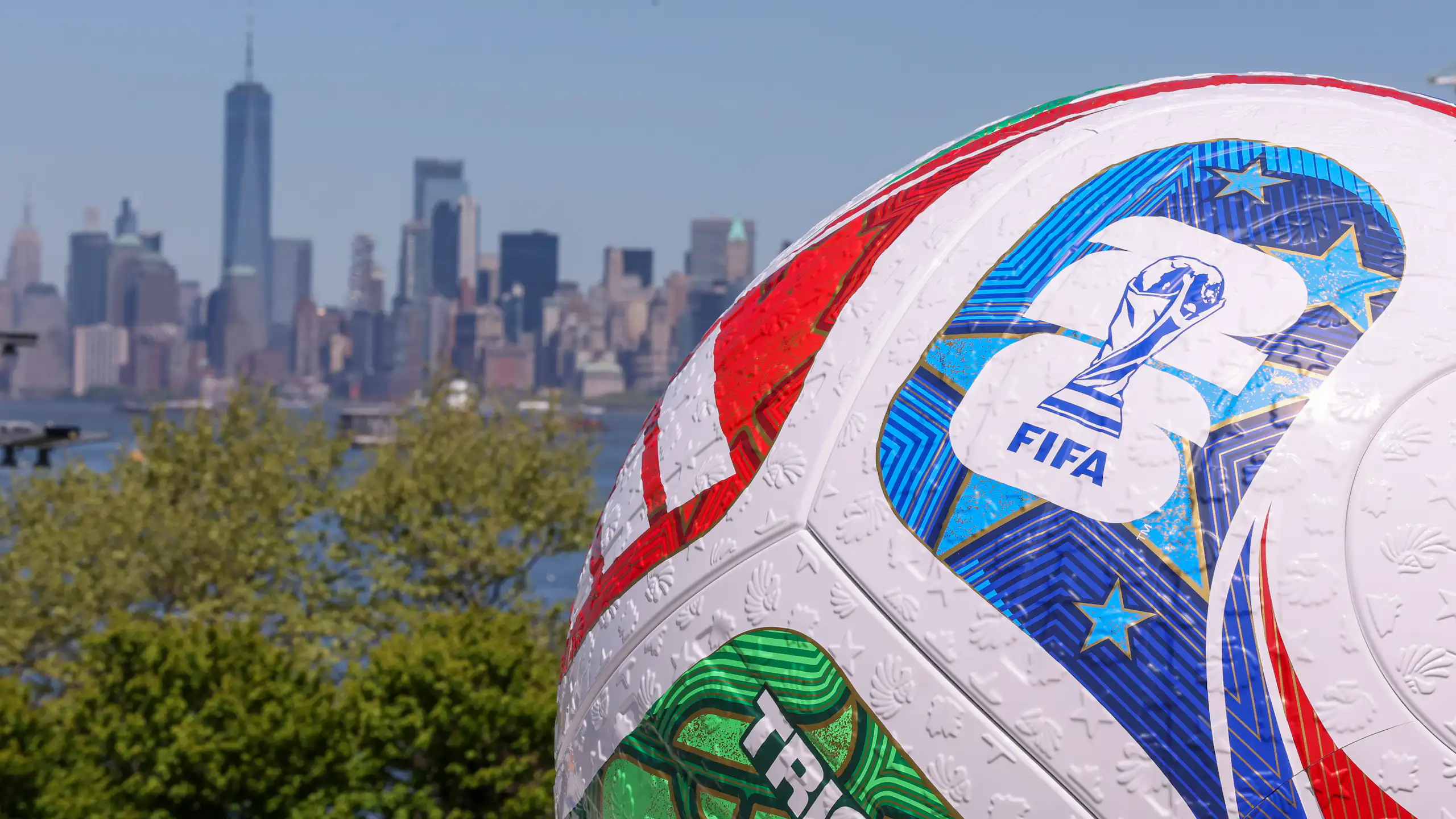 A replica World Cup soccer ball is seen with New York in the background.