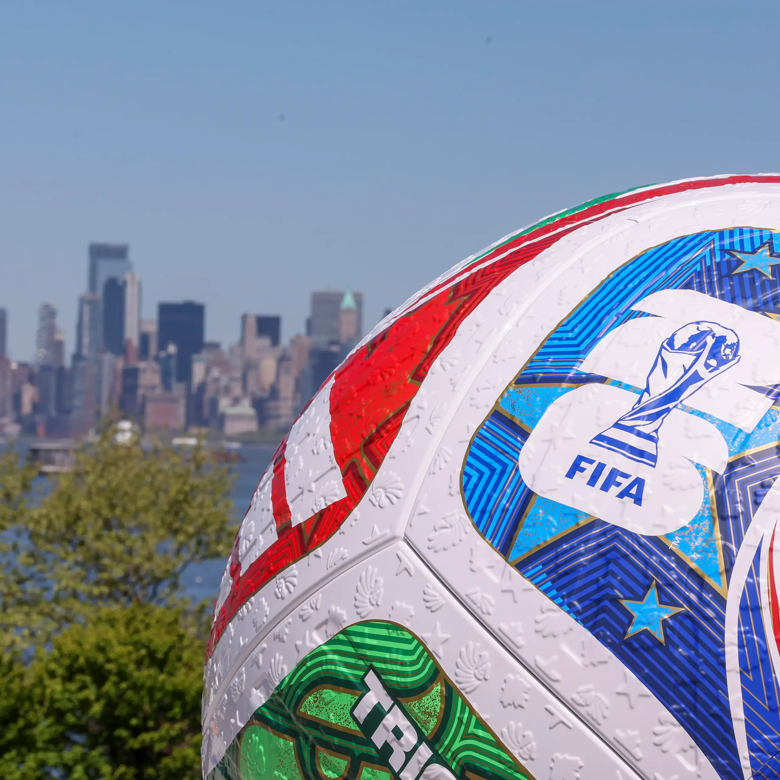 A replica World Cup soccer ball is seen with New York in the background.