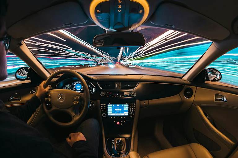 The interior of a car driving at night.