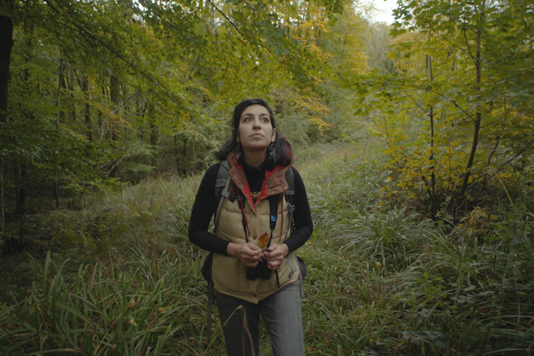 Naturalist and conservationist Nadia Shaikh walking in the woods