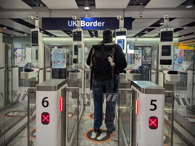 A man entering automated gates at the UK border