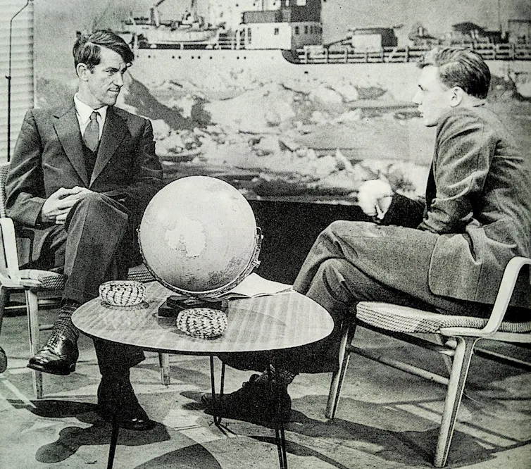 two men, black and white image, TV interview