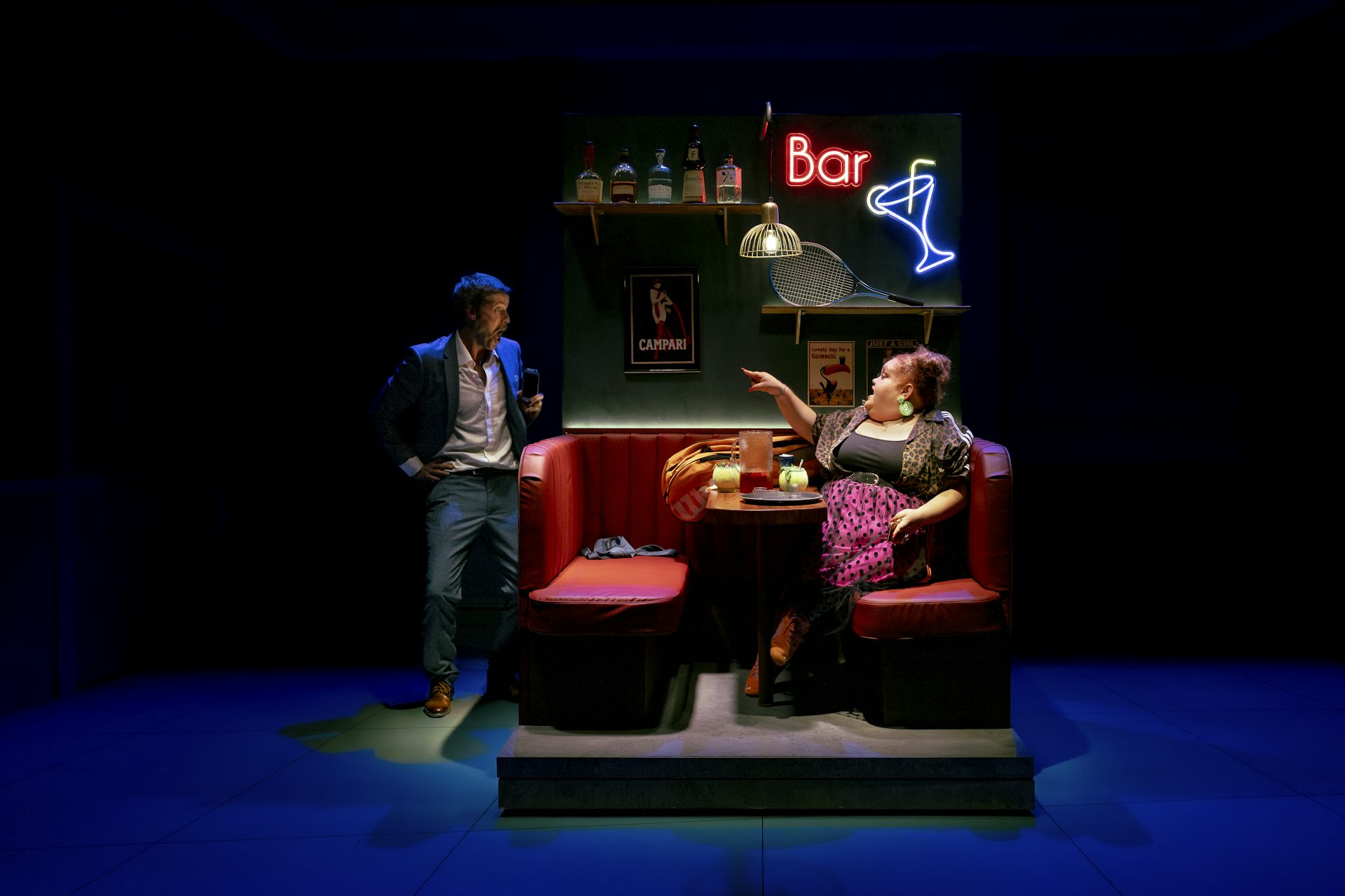 Production image: the pair spar in a bar.