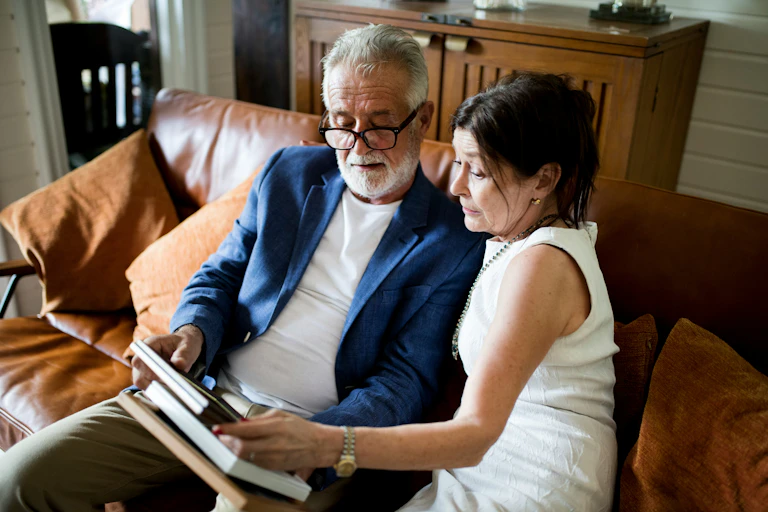 An older couple sitting on a sofa