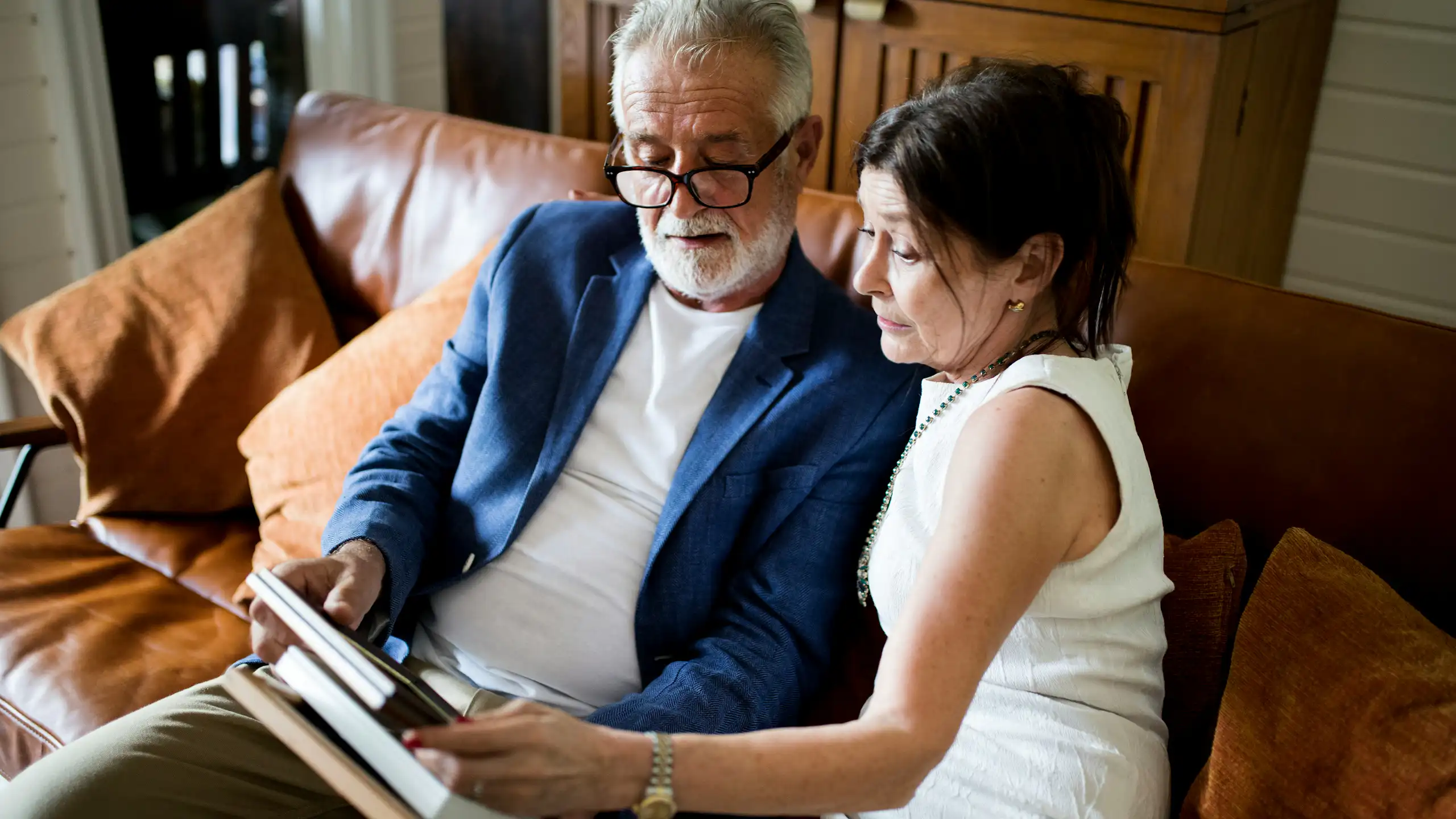 An older couple sitting on a sofa