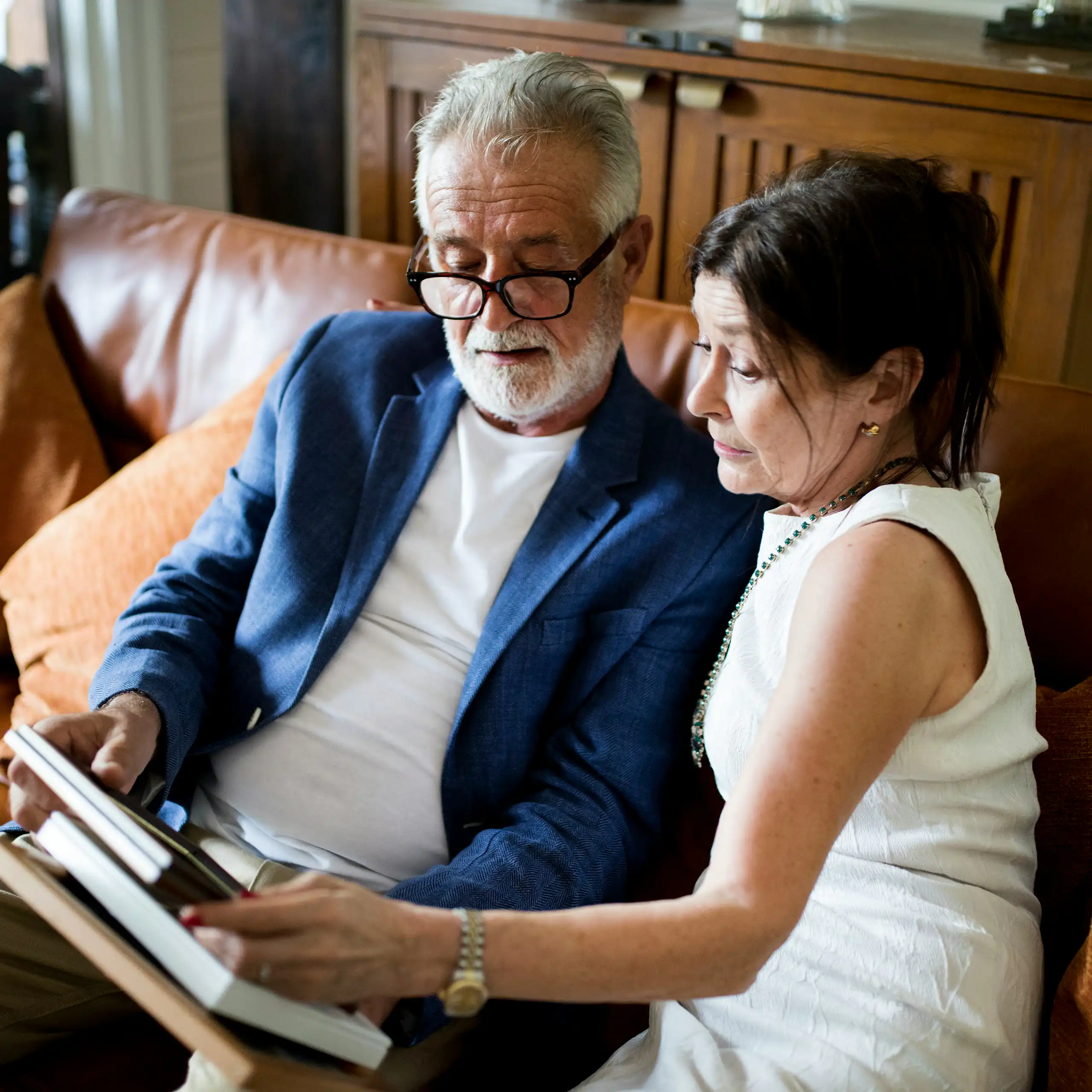An older couple sitting on a sofa