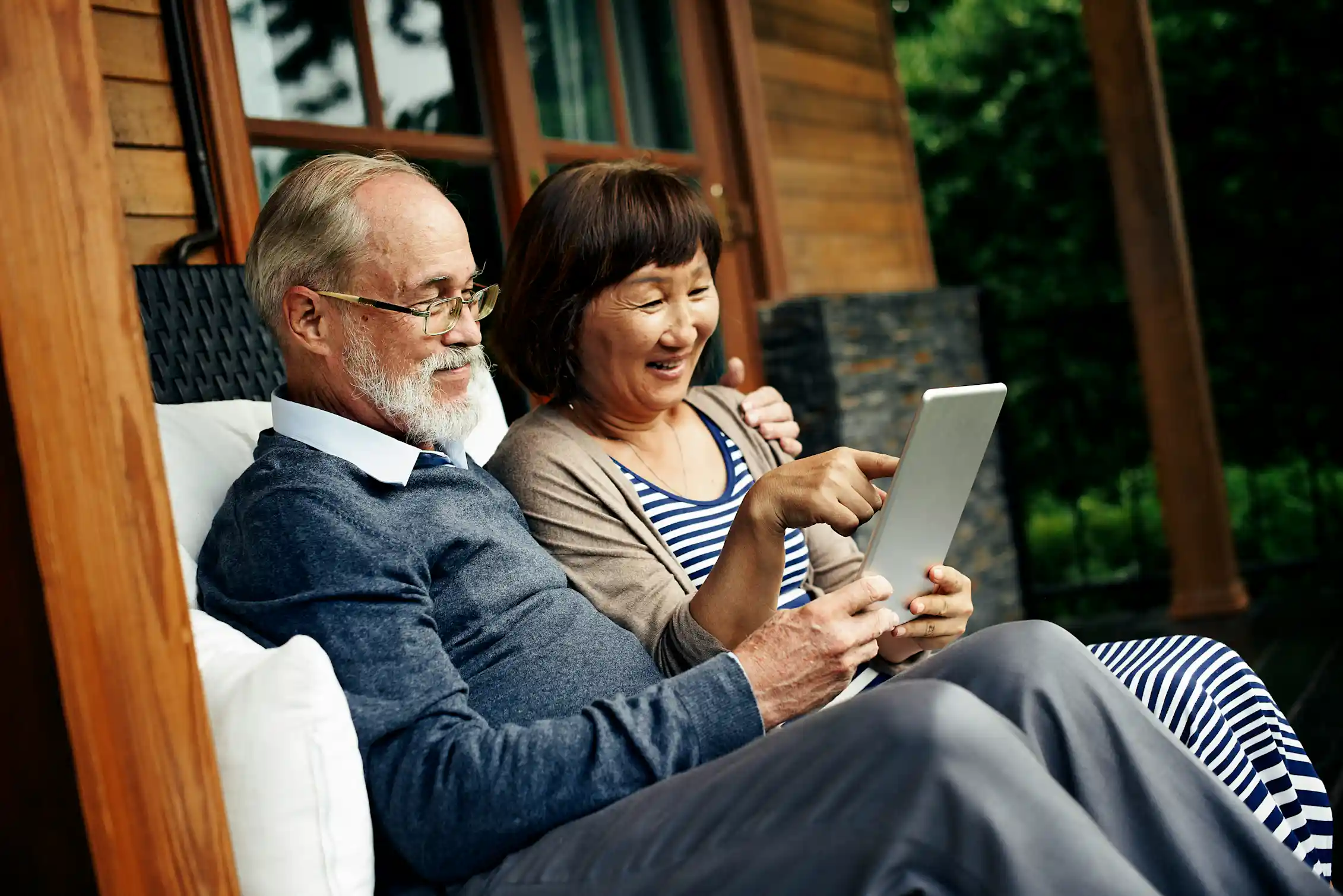 An older couple looking at a tablet screen