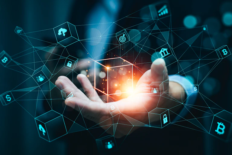 Illustration shows a person's hand with blockchain iconography