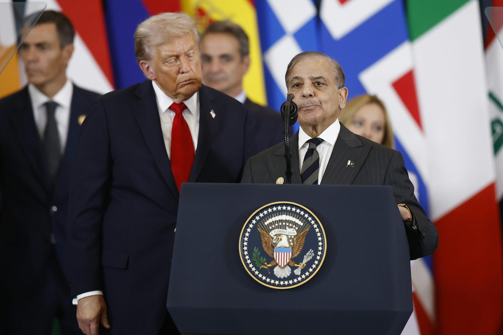 Donald Trump stands alongside Shehbaz Sharif as he delivers a speech.