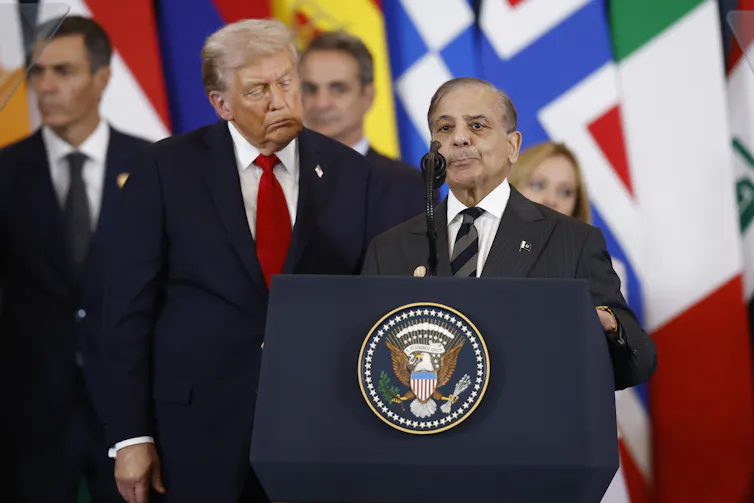 Donald Trump stands alongside Shehbaz Sharif as he delivers a speech.