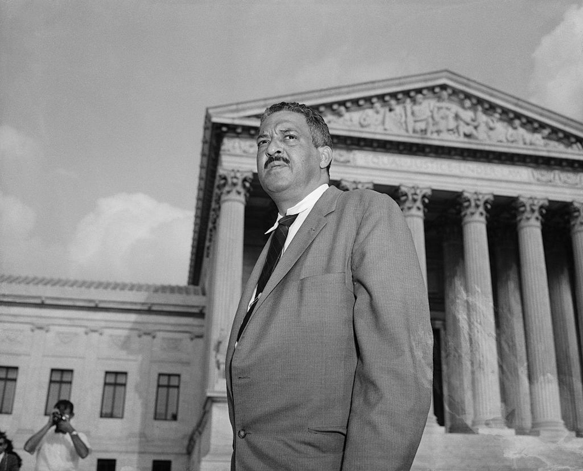 Thurgood Marshall standing outside the Supreme Court building