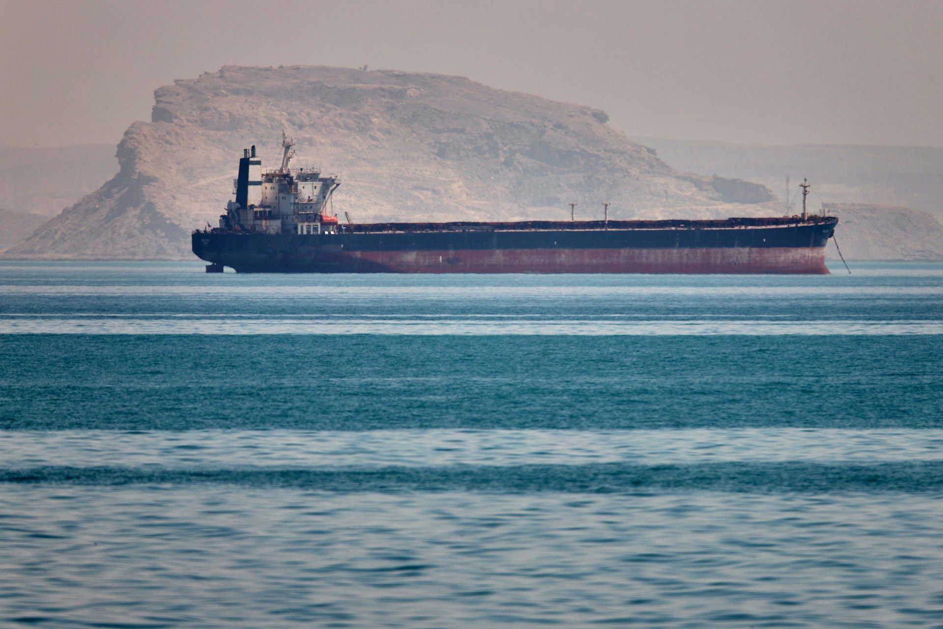 A bulk cargo ship floats on the ocean