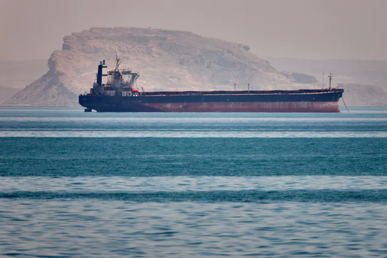 A bulk cargo ship floats on the ocean