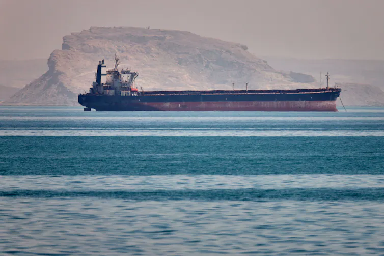 A bulk cargo ship floats on the ocean