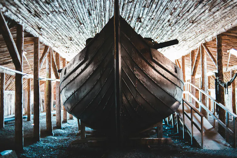 A Viking ship is displayed indoors.