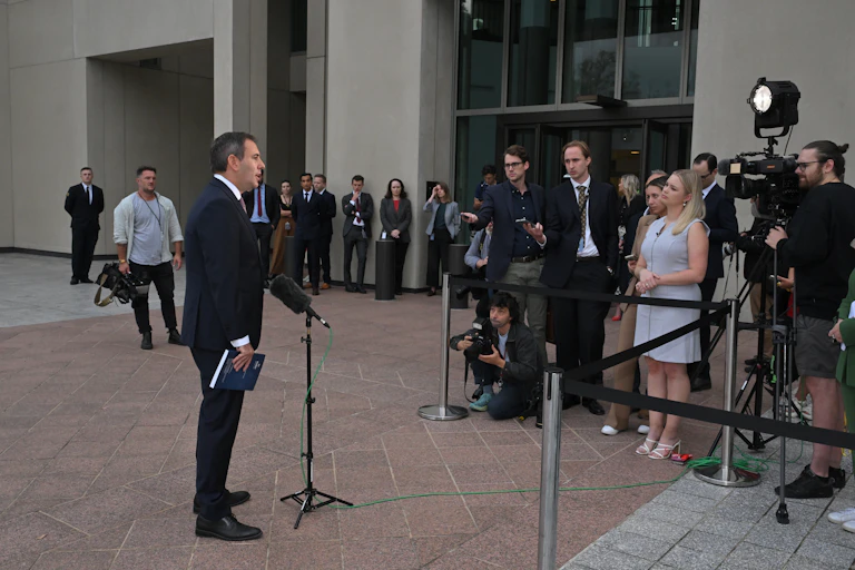 Treasurer Jim Chalmers gives an outdoor briefing to members of the media