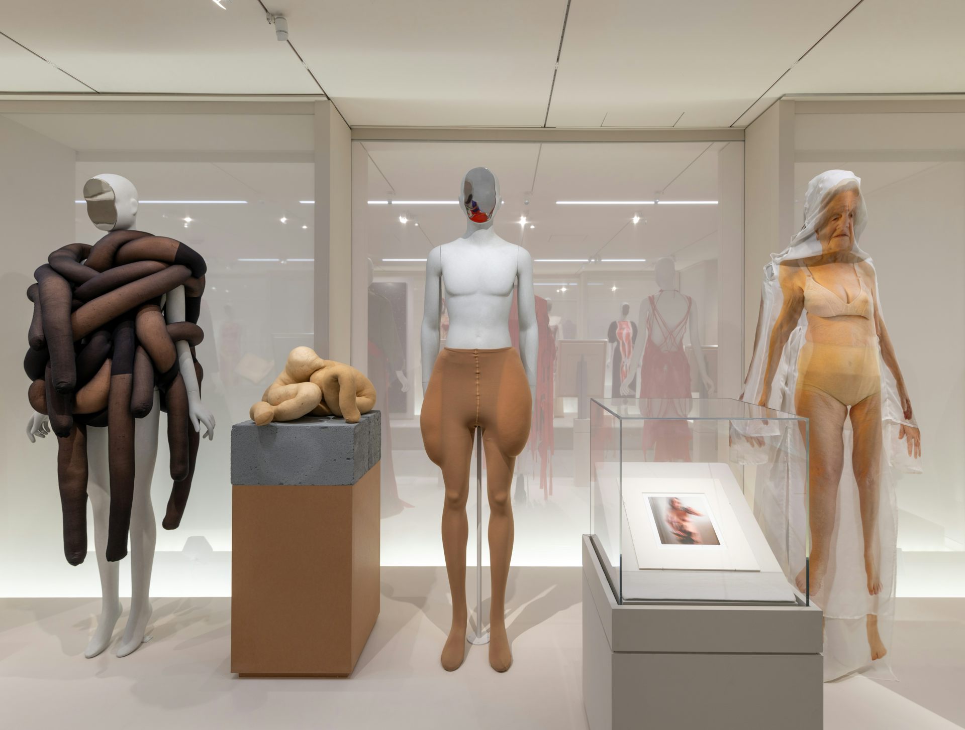 A museum display showing mannequins that are older in face and shape.