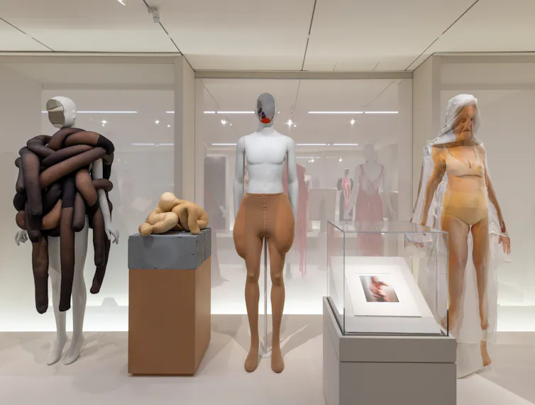 A museum display showing mannequins that are older in face and shape.