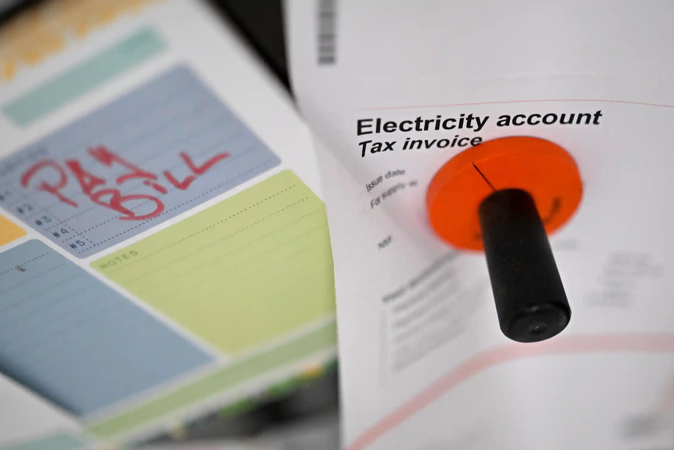 An electricity bill on a fridge door