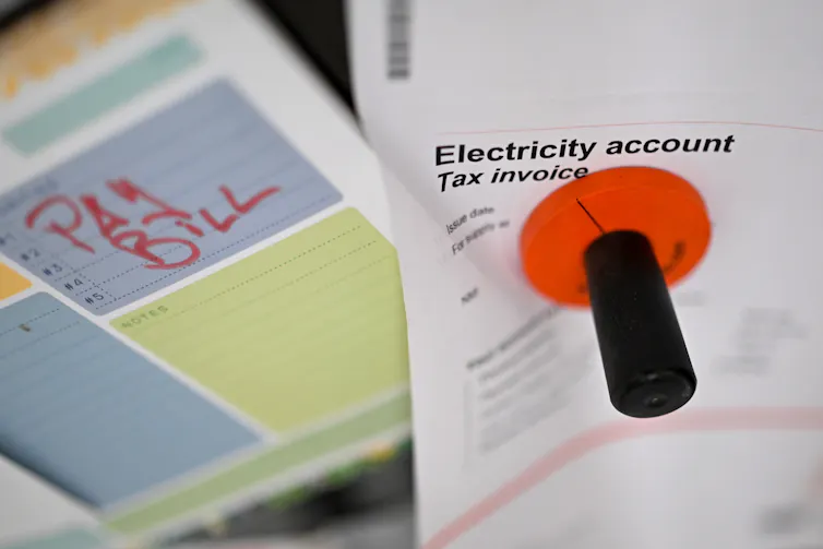 An electricity bill on a fridge door