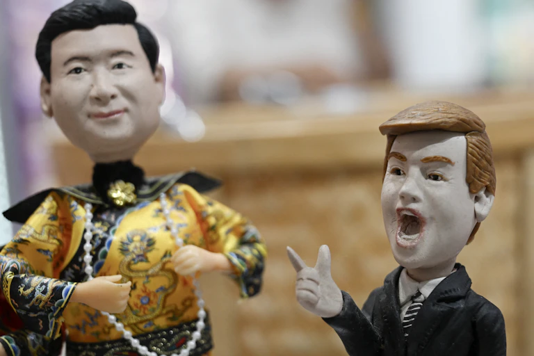 Two plastic figurines depicting men in suits.