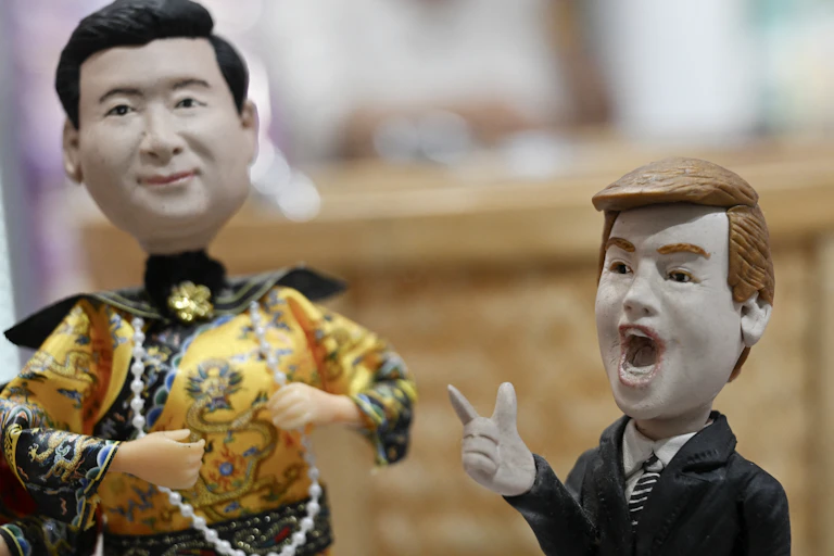Two plastic figurines depicting men in suits.
