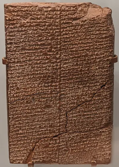 A rectangular tablet covered with tiny, cuneiform-like text.