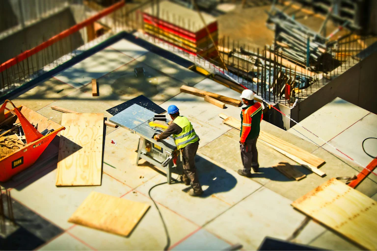 Construction workers work on a roof.