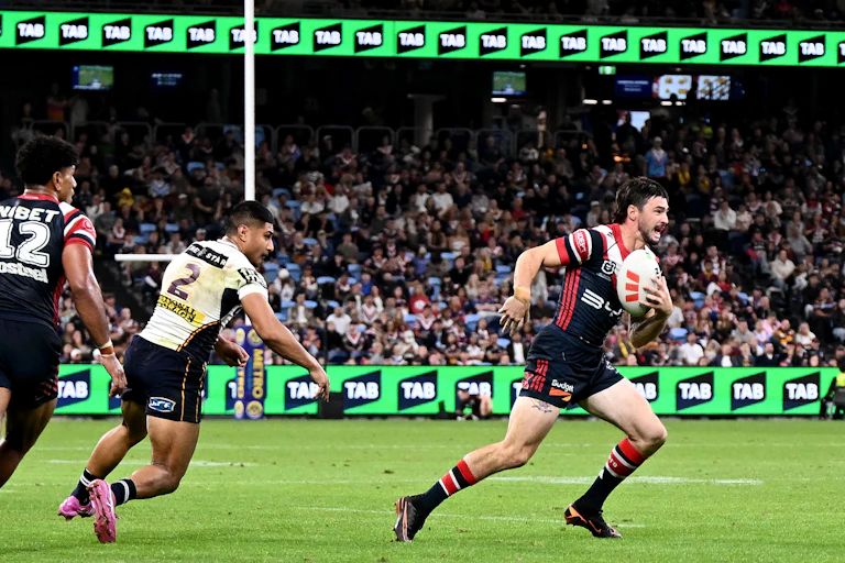 Cody Ramsey of the Roosters runs the ball during a 2026 NRL game, with gambling signage in the background.