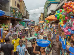 A busy area with numerous market stalls and people shopping