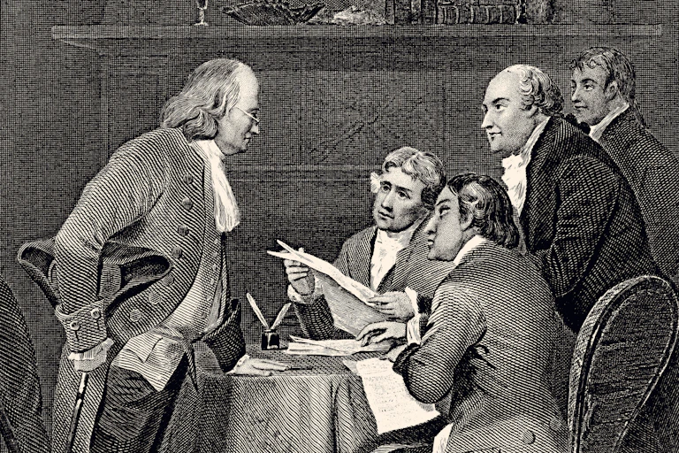 Five men in colonial dress, sitting and standing around a table.