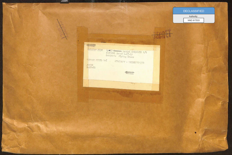 An old yellow envelope with a label reading AIRCRAFT - UNIDENTIFIED, stamps reading SECRET, and a digital annotation reading DECLASSIFIED