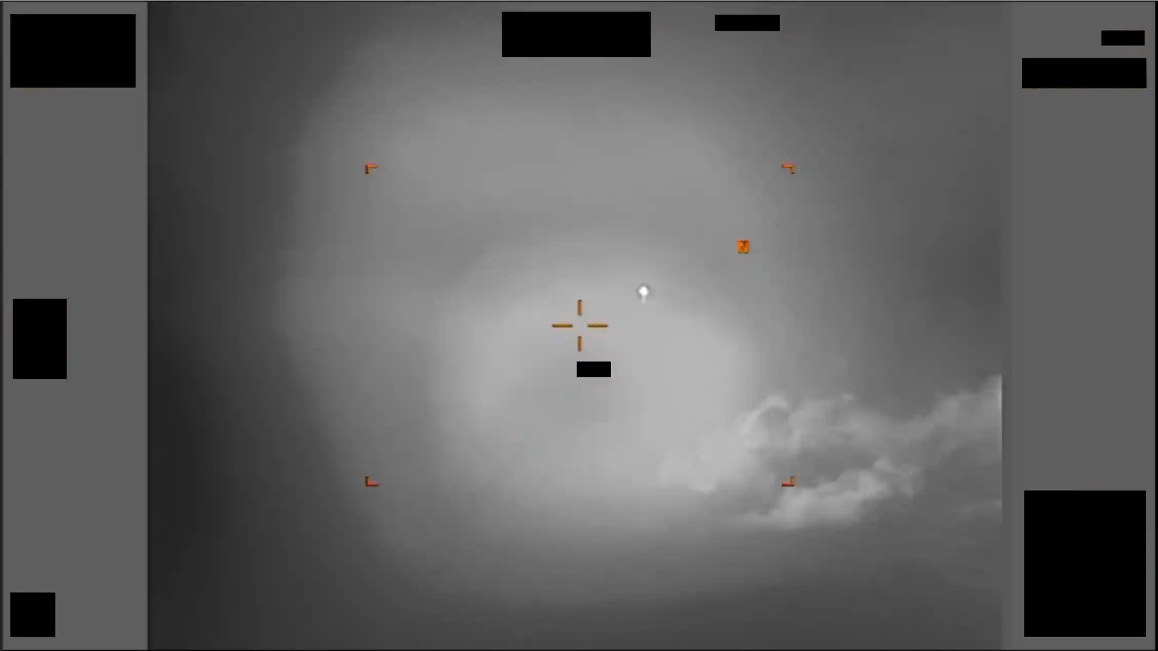 A grey scale image showing sights and a white diamond against a cloudy background.