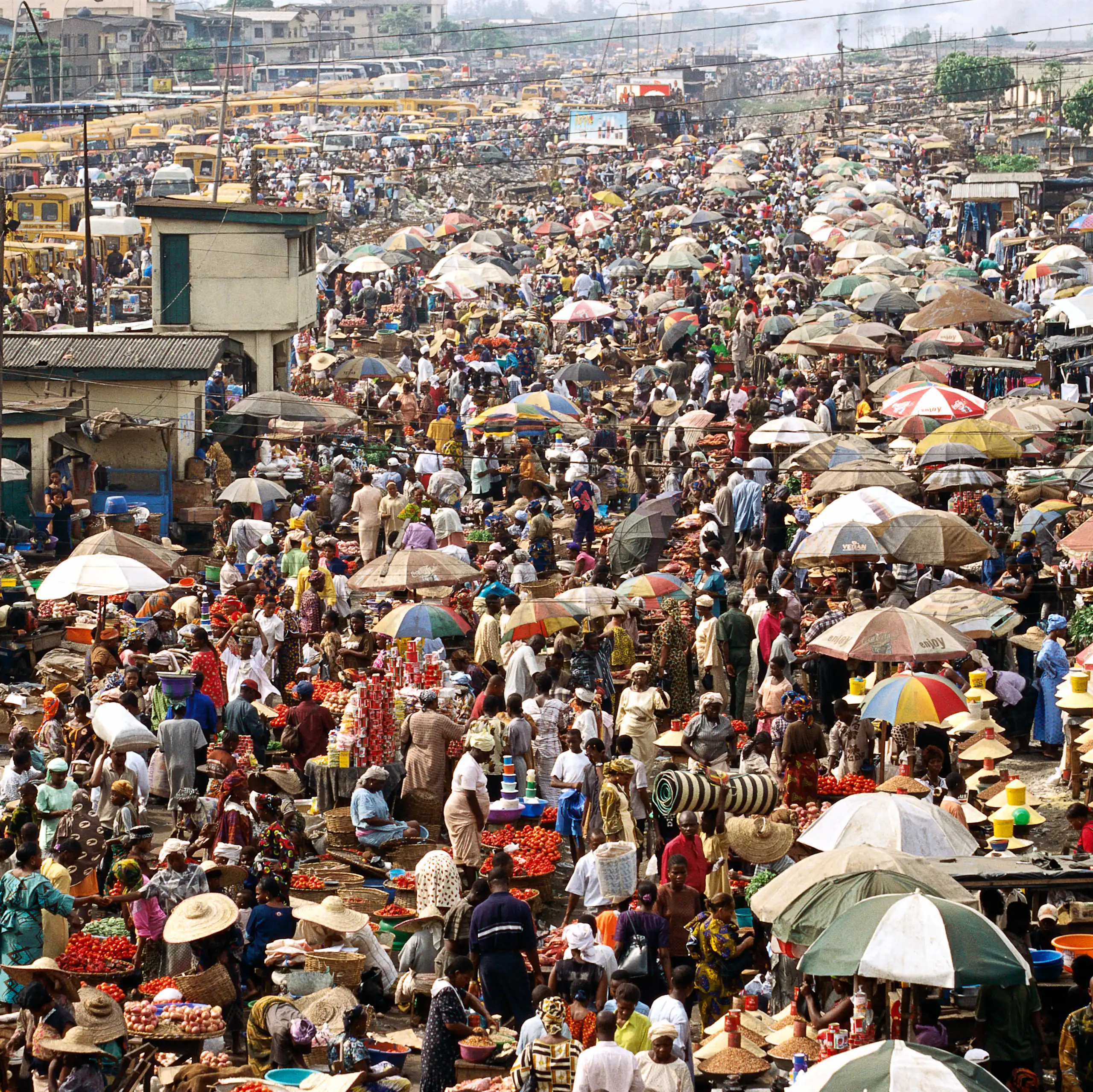 A very busy open air marketplace with hundreds of stalls and customers