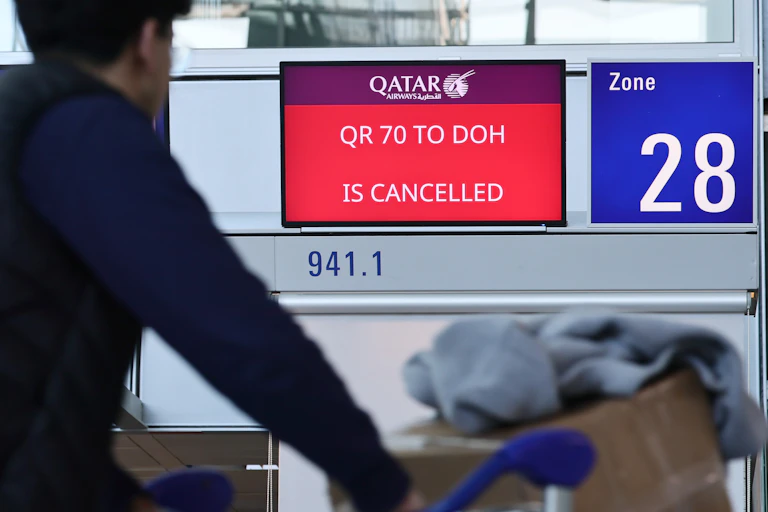 A digital board showing a cancelled Qatar Airways flight at Frankfurt International Airport in Germany.