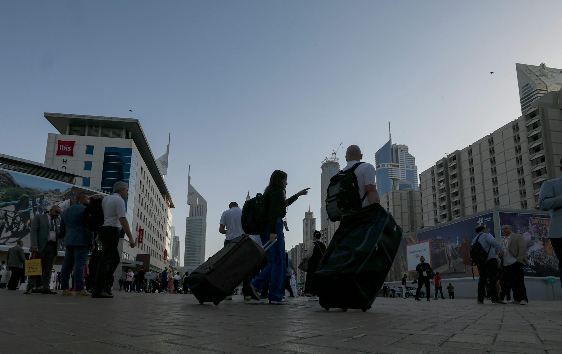 Tourists carrying their luggage through Dubai.