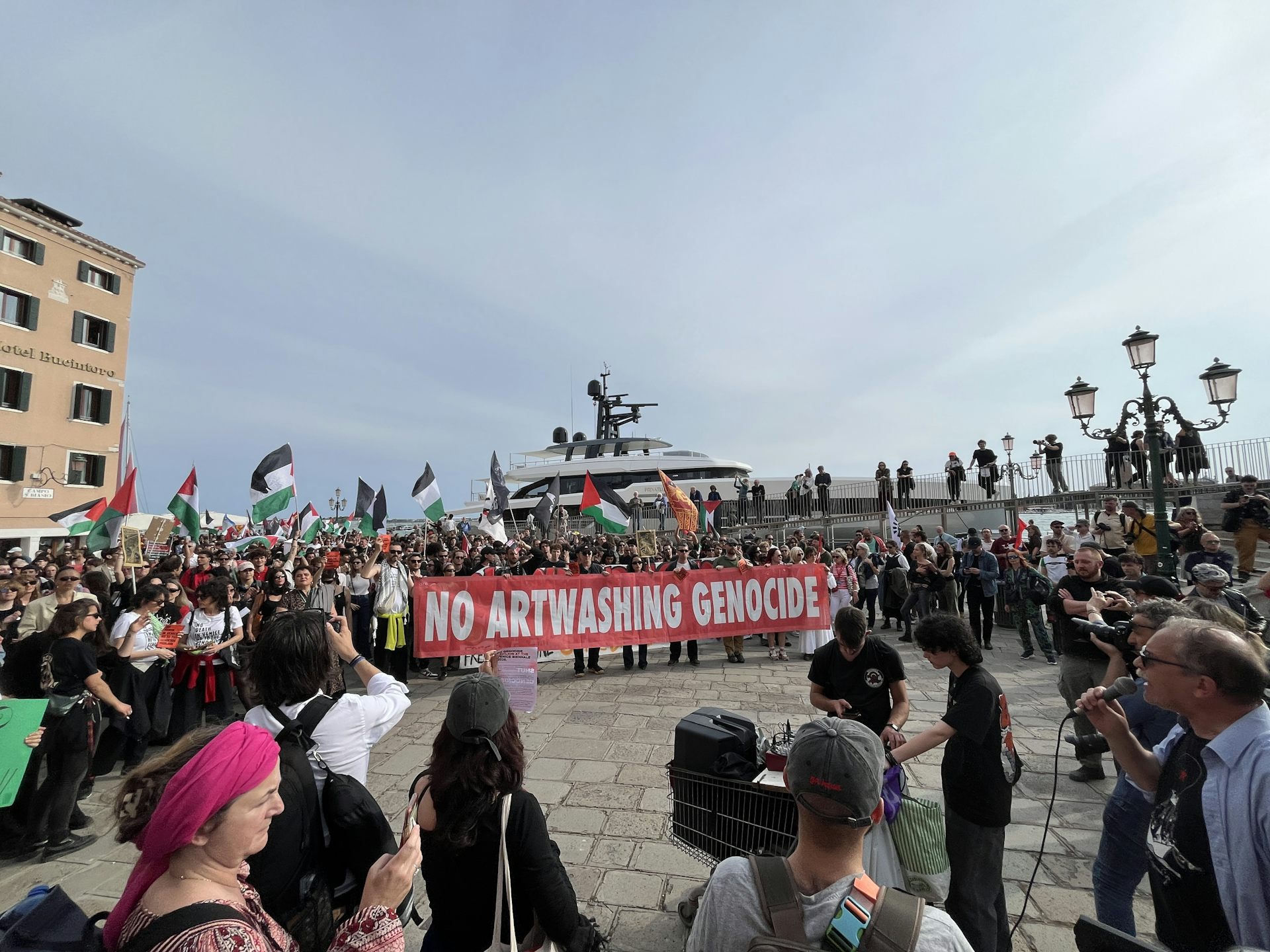 protestors in front of a super yacht