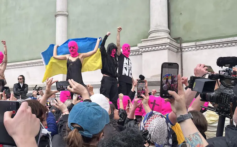 Pussy Riot protestors holding a Ukraine flag