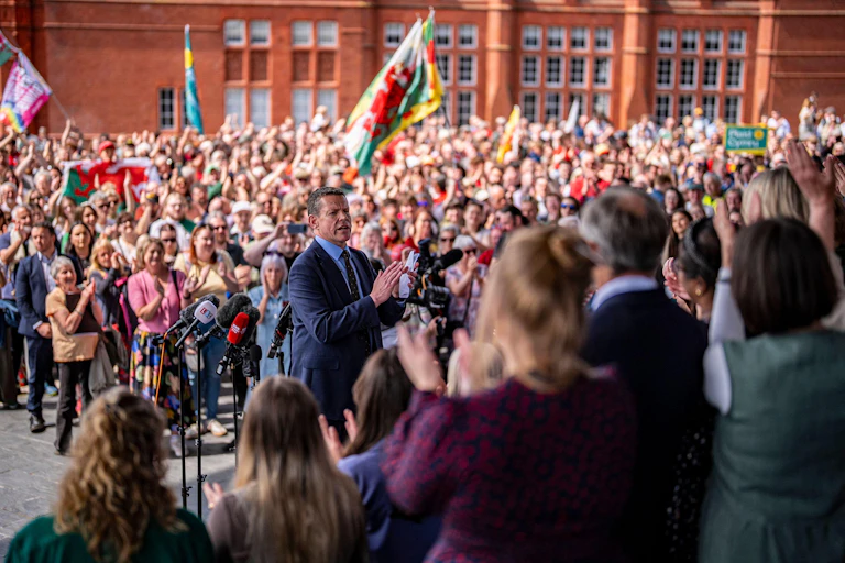 Rhun ap Iorwerth with a large crowd of people behind and in front of him.